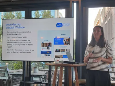 Kate is wearing a a striped top speaking beside a screen showing Sue Ryder's website redesign, with before-and-after screenshots.