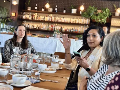 Dhanya chats expressively to other guests.