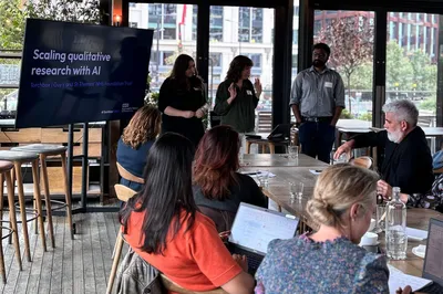 Emma, Cassie and Madhav talk in front of the audience at the event.