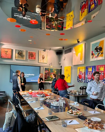 Charity CEOs network at a breakfast event featuring a presentation on AI and strategic leadership.