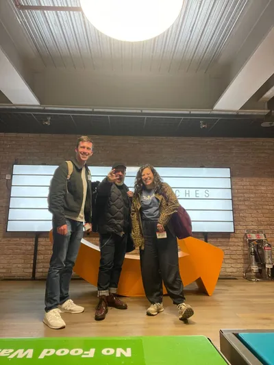 Ellie, Mark and Dom from Torchbox standing together and smiling at the LGRCamp venue after leading their workshop session.