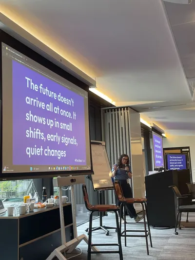 Ellie Ashman presenting during the Torchbox workshop at LGRCamp, standing beside presentation slides about future thinking and local government reorganisation.