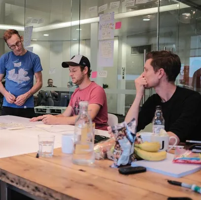 Torchbox team gather round table