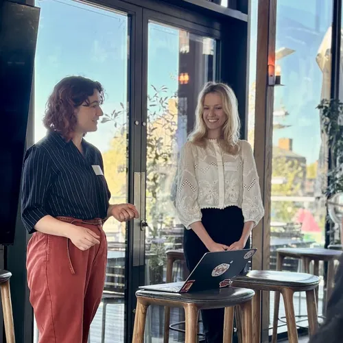 Natasha from the Disasters Emergency Committee and Iona from Torchbox presenting together at an event.